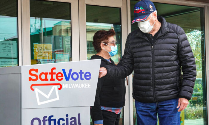 Residents drop mail-in ballots in a ballot box outside of the Tippecanoe branch library in Milwaukee on Oct. 20, 2020. (Scott Olson/Getty Images)