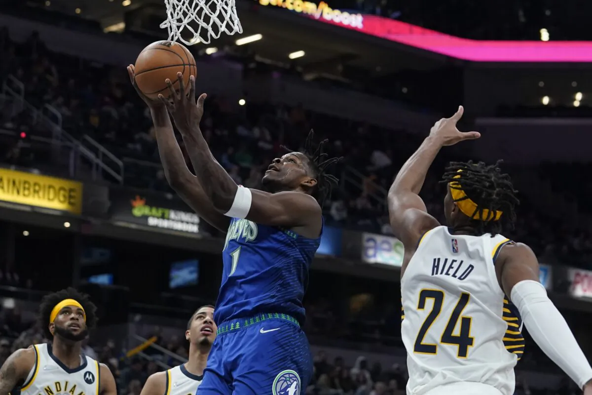 Minnesota Timberwolves' Anthony Edwards (1) shoots against Indiana Pacers' Buddy Hield (24) during the first half of an NBA basketball game in Indianapolis, on Feb. 13, 2022. (Darron Cummings/AP Photo)