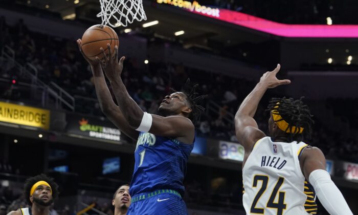 Minnesota Timberwolves' Anthony Edwards (1) shoots against Indiana Pacers' Buddy Hield (24) during the first half of an NBA basketball game in Indianapolis, on Feb. 13, 2022. (Darron Cummings/AP Photo)
