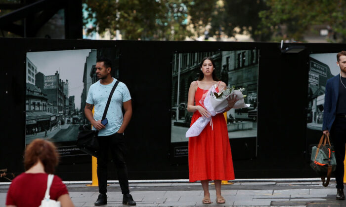 A woman is seen holding flowers as she makes her way through Martin Place during Valentines Day, in Sydney, Australia, on Feb. 14, 2020. (Lisa Maree Williams/Getty Images)