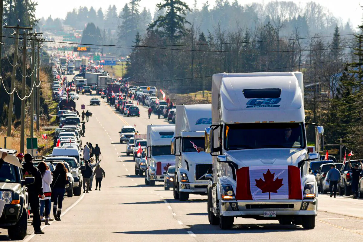 Trucks and other vehicles drive on Highway 15 near the Pacific Highway Border Crossing, as part of a protest convoy demonstrating against COVID-19 mandates and restrictions, in Surrey, B.C., on February 12, 2022. (Jason Redmon/AFP via Getty Images)