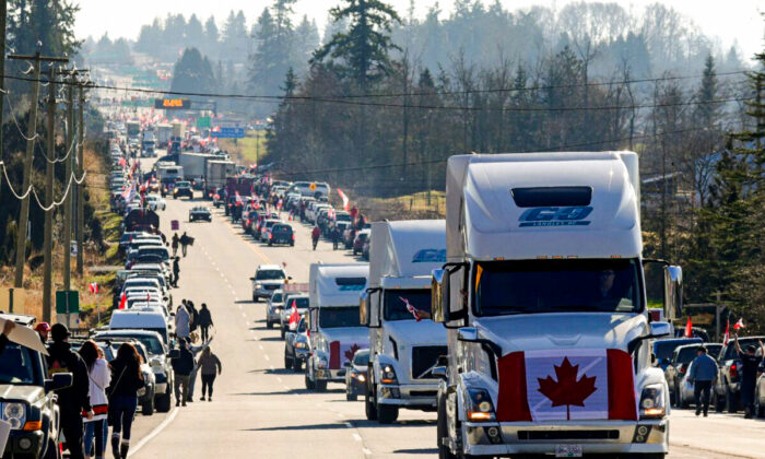 Trucks and other vehicles drive on Highway 15 near the Pacific Highway Border Crossing, as part of a protest convoy demonstrating against COVID-19 mandates and restrictions, in Surrey, B.C., on February 12, 2022. (Jason Redmon/AFP via Getty Images)