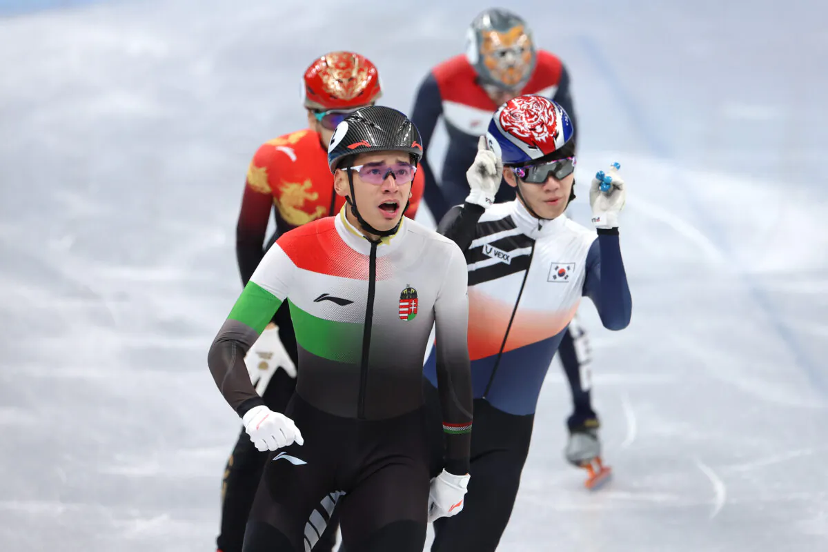 Shaolin Sandor Liu of Team Hungary and Juneseo Lee of Team South Korea react after skating during the Men's 1,000 m Semifinals on day three of the Beijing 2022 Winter Olympic Games at Capital Indoor Stadium in Beijing, on Feb. 7, 2022. (Lintao Zhang /Getty Images)