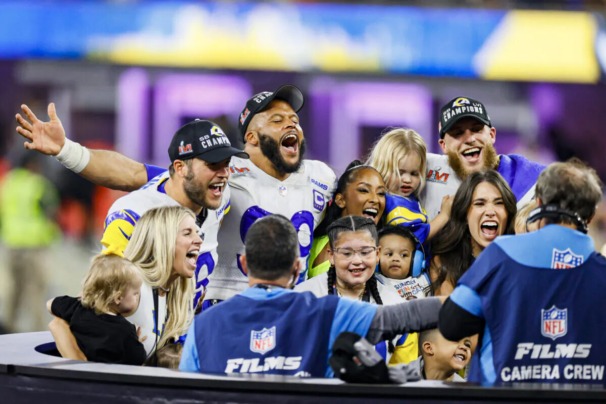 Matthew Stafford (L), Aaron Donald #99 (C), and Cooper Kupp (R), of the Los Angeles Rams celebrate with their families following Super Bowl LVI at SoFi Stadium, in Inglewood, Calif., on February 13, 2022. (Steph Chambers/Getty Images)
