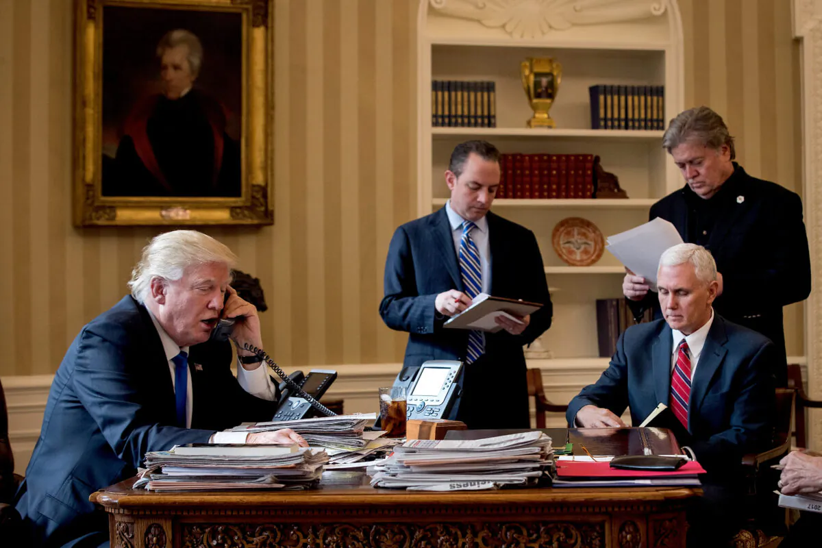 President Donald Trump speaks on the phone with Russian President Vladimir Putin in the Oval Office of the White House, on Jan. 28, 2017. (Drew Angerer/Getty Images)