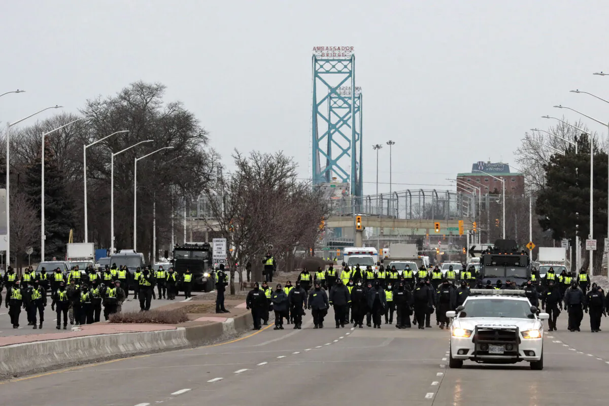 Police arrest protesters near the Ambassador Bridge in Windsor, Canada on Feb. 13, 2022. (Jeff Kowalsky/AFP via Getty Images)