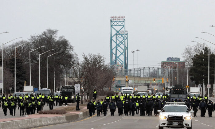 Police arrest protesters near the Ambassador Bridge in Windsor, Canada, on Feb. 13, 2022. (Jeff Kowalsky/AFP via Getty Images)