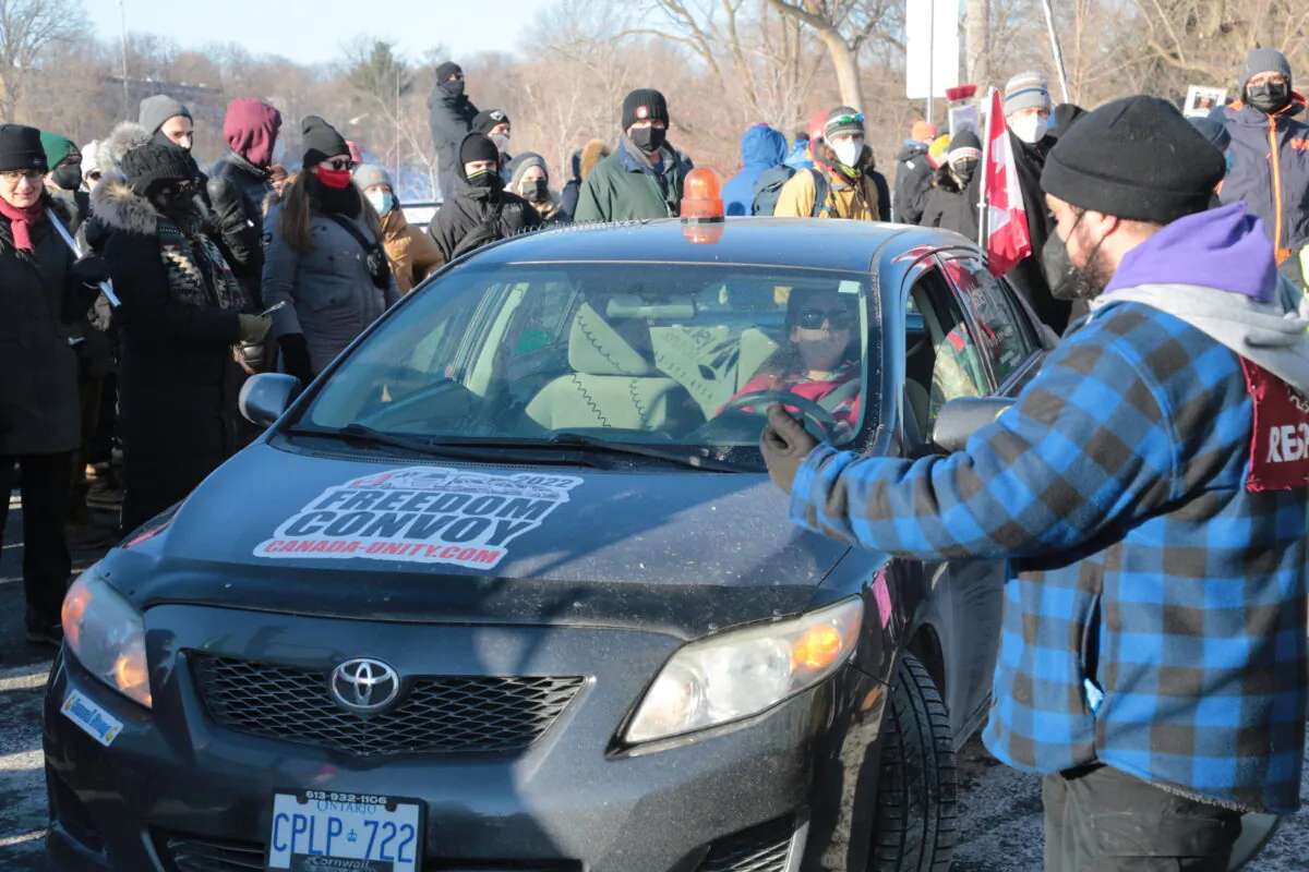 A trapped pro-trucker protest driver was eventually allowed to leave after she was blocked by counter-protesters, in Ottawa, Canada, on Feb. 13, 2022. (Richard Moore/The Epoch Times)