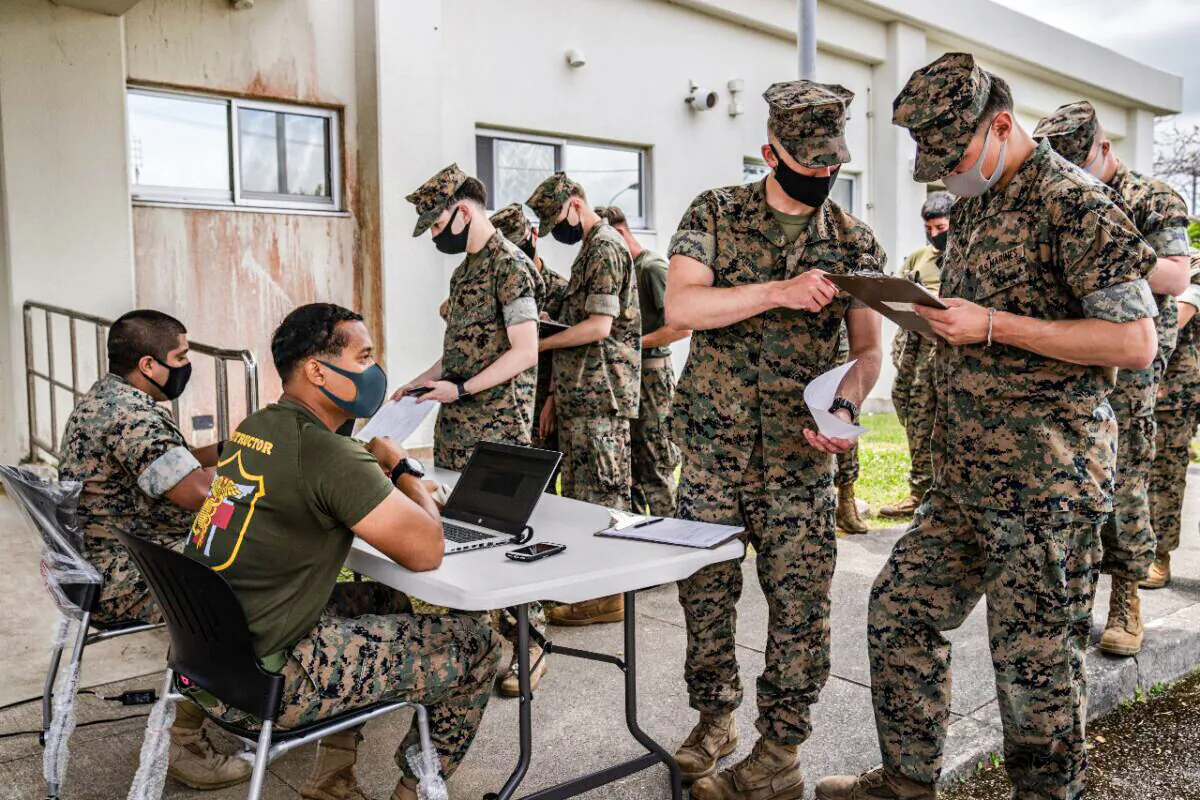United States Marines register their details as they queue to receive the Moderna coronavirus vaccine at Camp Hansen in Kin, Japan on April 28, 2021. (Carl Court/Getty Images)