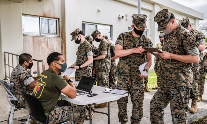 United States Marines register their details as they queue to receive the Moderna coronavirus vaccine at Camp Hansen on April 28, 2021 in Kin, Japan.  (Carl Court/Getty Images)