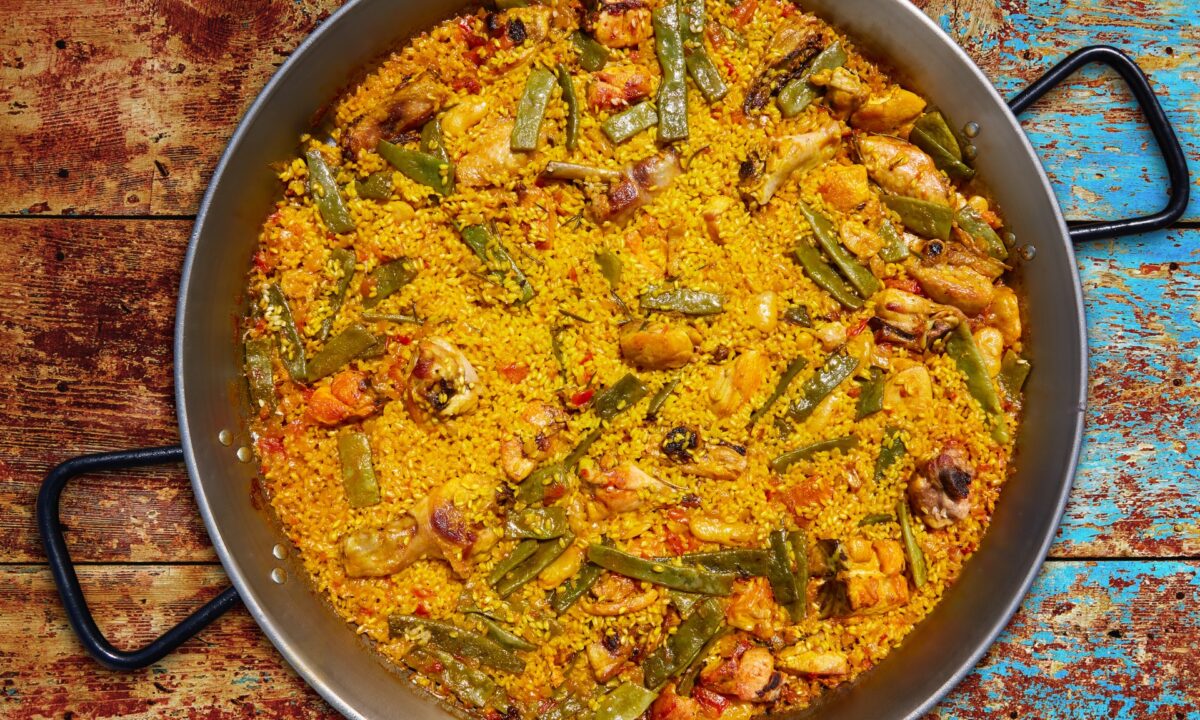 Traditional paella Valenciana, a meal of the Valencian countryside, is made with chicken, rabbit, green beans, and other ingredients from the surrounding land—including the all-important arroz. (LunaMarina/Shutterstock)