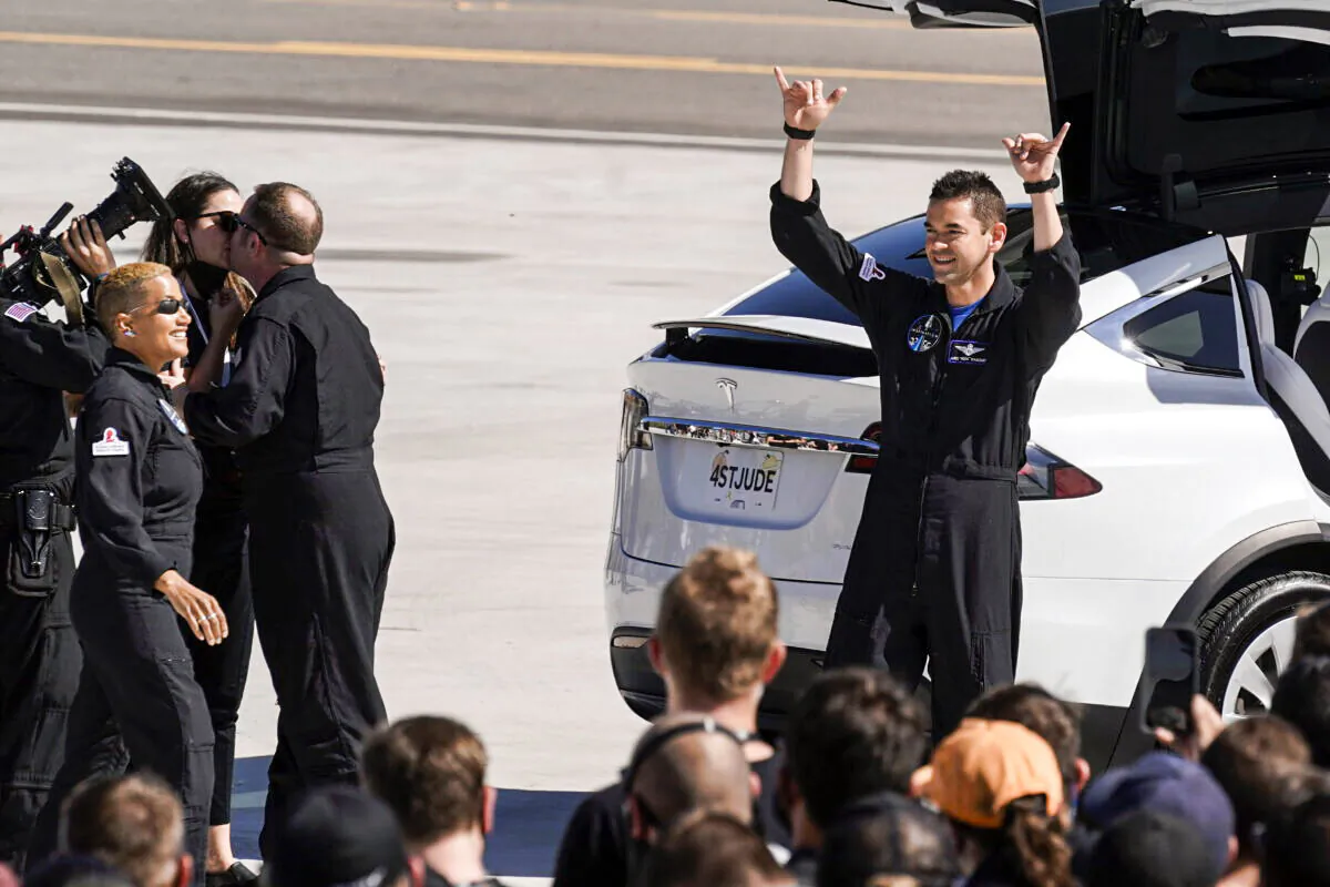 Inspiration4 crew member Jared Isaacman (R) waves to family members before a trip to Kennedy Space Center's Launch Pad 39-A and a planned liftoff on a SpaceX Falcon 9 rocket in Cape Canaveral, Fla., on Sept. 15, 2021. (John Raoux/AP Photo)