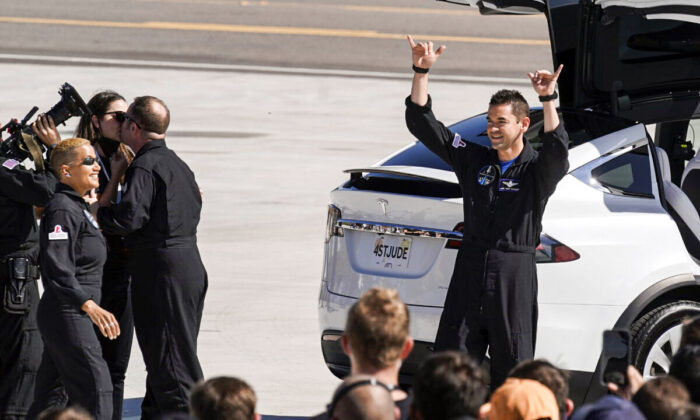 Inspiration4 crew member Jared Isaacman (R) waves to family members before a trip to Kennedy Space Center's Launch Pad 39-A and a planned liftoff on a SpaceX Falcon 9 rocket in Cape Canaveral, Fla., on Sept. 15, 2021. (John Raoux/AP Photo)