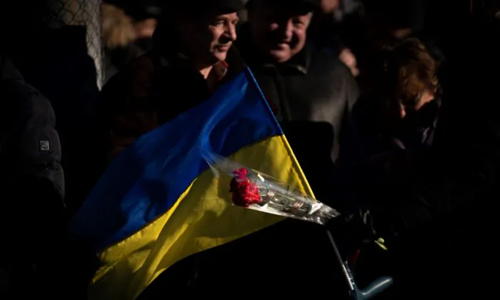 People attend a ceremony to mark the anniversary of the withdrawal of Soviet troops from Afghanistan in the city of Kyiv, Ukraine, on  Feb. 15, 2022. (Emilio Morenatti/AP Photo)