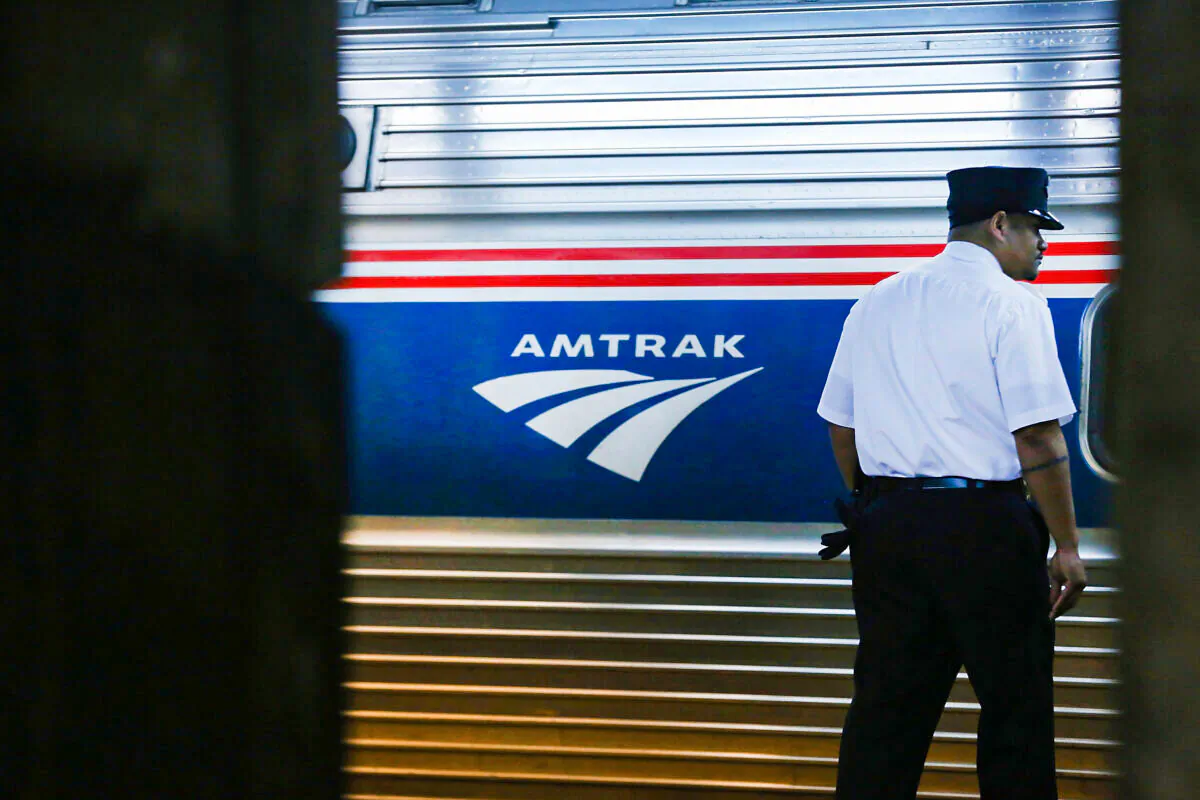 A train conductor stands next to an Amtrak train at New York's Pennsylvania Station in New York on Feb. 16, 2018. (Spencer Platt/Getty Images)