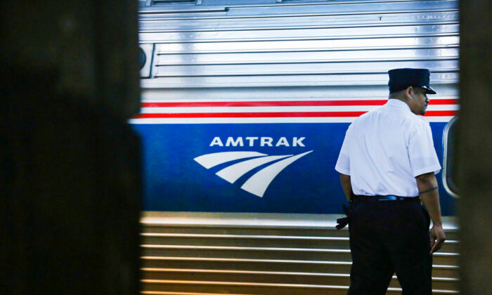A train conductor stands next to an Amtrak train at New York's Pennsylvania Station in New York on Feb. 16, 2018. (Spencer Platt/Getty Images)