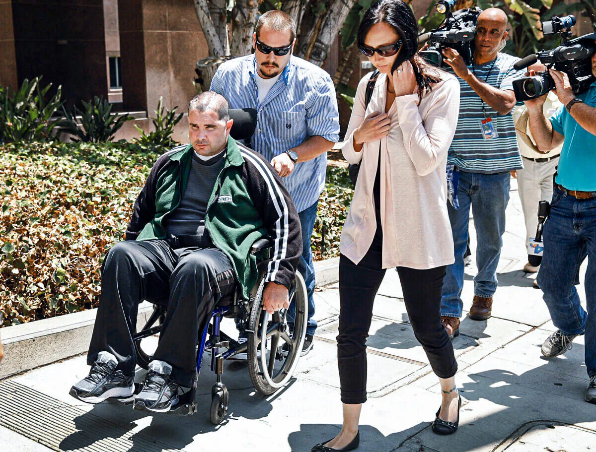 A wheelchair-bound Bryan Stow assisted by a caregiver is surrounded by his sisters Bonnie Stow, right, Erin Collins, not pictured, mother Ann Stow, and father David Stow as he departs the Los Angeles County Superior Courthouse in downtown LA Wednesday morning May 28, 2014. (Al Seib/Los Angeles Times/TNS)