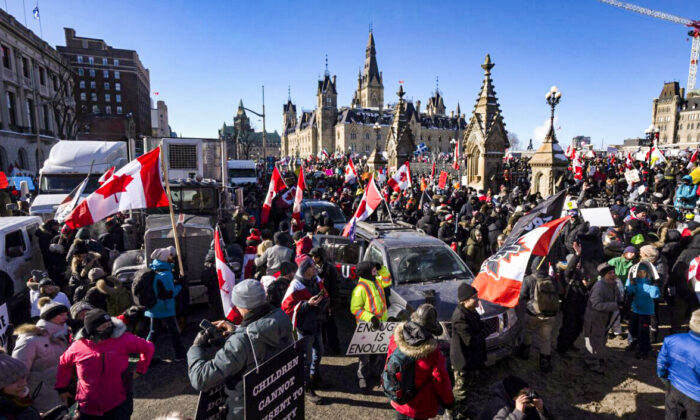 Protesters stand on the back of a truck during the Freedom Convoy demonstrations against COVID-19 vaccine mandates and other restrictions on Parliament Hill in Ottawa on Jan. 29, 2022. (Adrian Wyld/The Canadian Press)