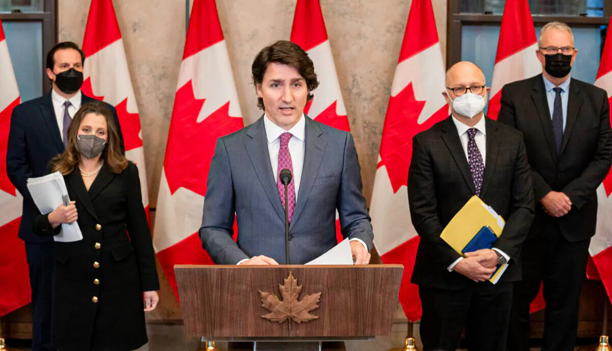 Prime Minister Justin Trudeau along with some of his cabinet ministers speaks at a press conference in Ottawa on Feb. 14, 2022.  (The Canadian Press/Adrian Wyld)