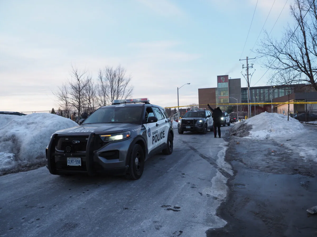 Police leave the scene at David and Mary Thomson Collegiate in Scarborough, where an 18-year-old male high school student was killed just after 3pm, in Toronto, on Feb. 14, 2022. (The Canadian Press/Arlyn Mcadorey)