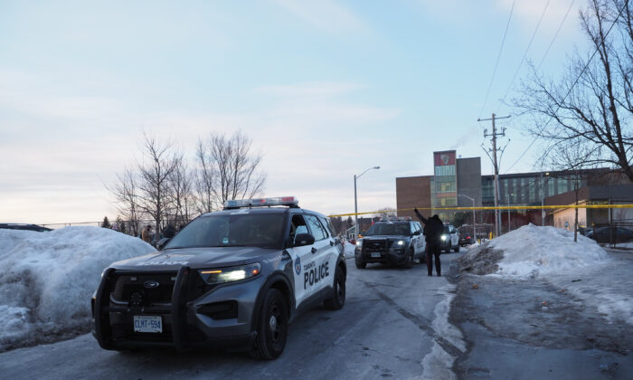 Police leave the scene at David and Mary Thomson Collegiate in Scarborough, where an 18-year-old male high school student was killed just after 3pm, in Toronto, on Feb. 14, 2022. (The Canadian Press/Arlyn Mcadorey­)