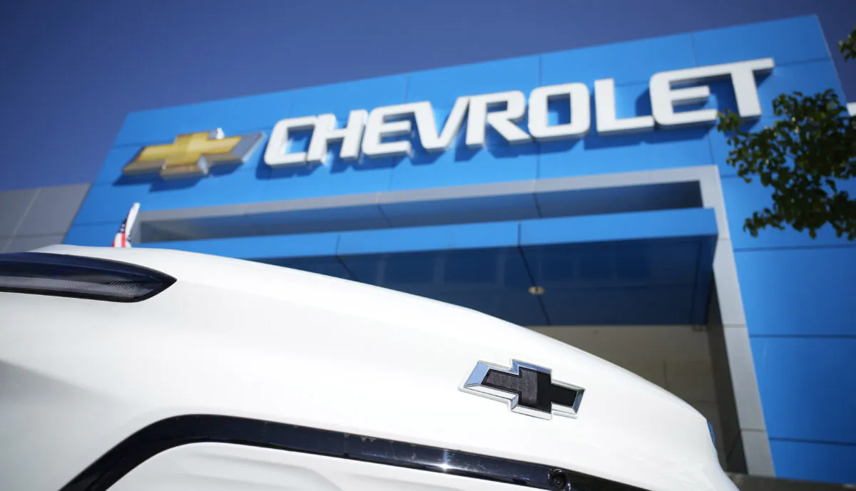 The company logo shines off the nose of a Bolt electric vehicle on display in front of a Chevrolet dealership in Englewood, Colo, on Sept. 12, 2021. (David Zalubowski/AP Photo)