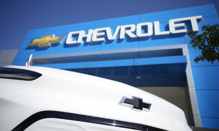The company logo shines off the nose of a Bolt electric vehicle on display in front of a Chevrolet dealership in Englewood, Colo, on Sept. 12, 2021. (David Zalubowski/AP Photo)