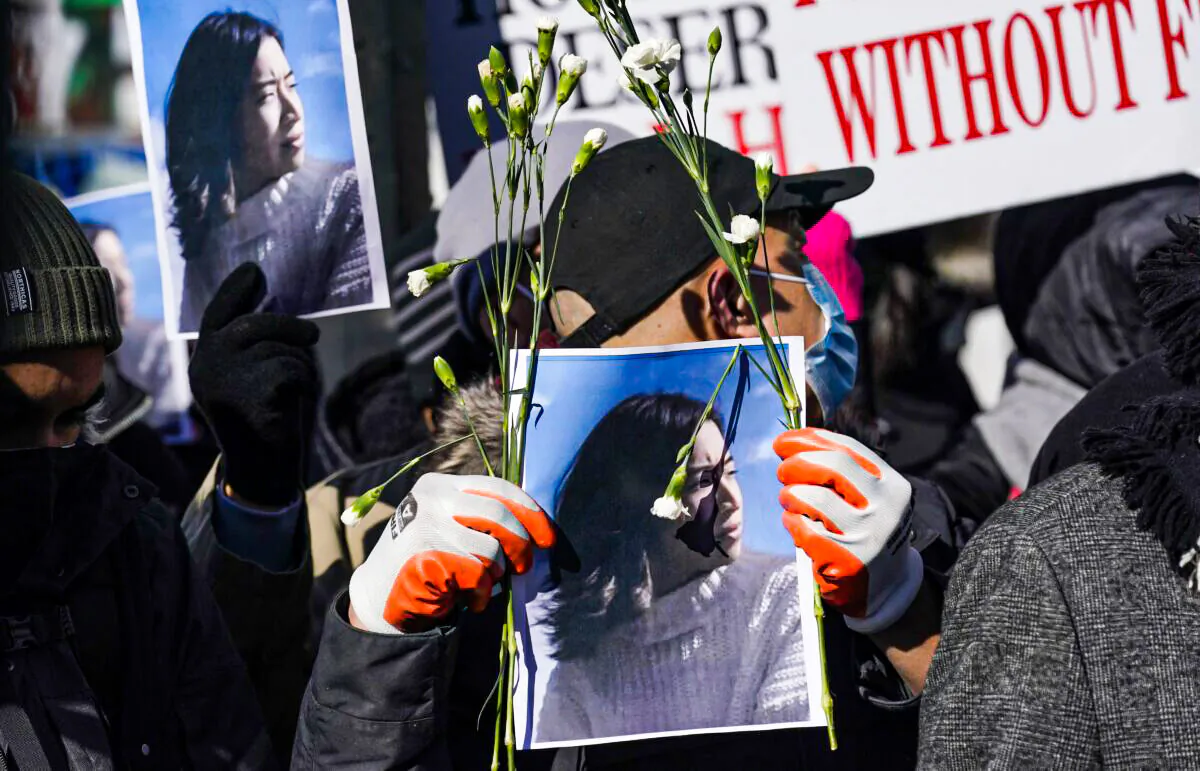 People hold signs and pictures of Christina Yuna Lee, during a rally in the Chinatown section of New York, on Feb. 14, 2022. (Seth Wenig/AP Photo)