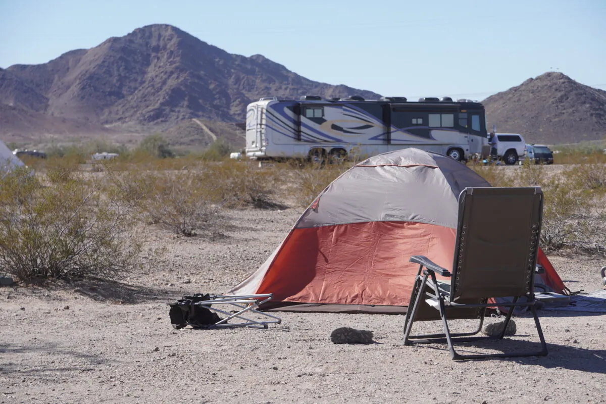 A fold-out chair and tent stand among the hundreds of long-term visitors at the Bureau of Land Management's La Posa Long-Term Visitor Area in Quartzsite, Ariz., on Feb. 12, 2022. (Allan Stein/The Epoch Times)