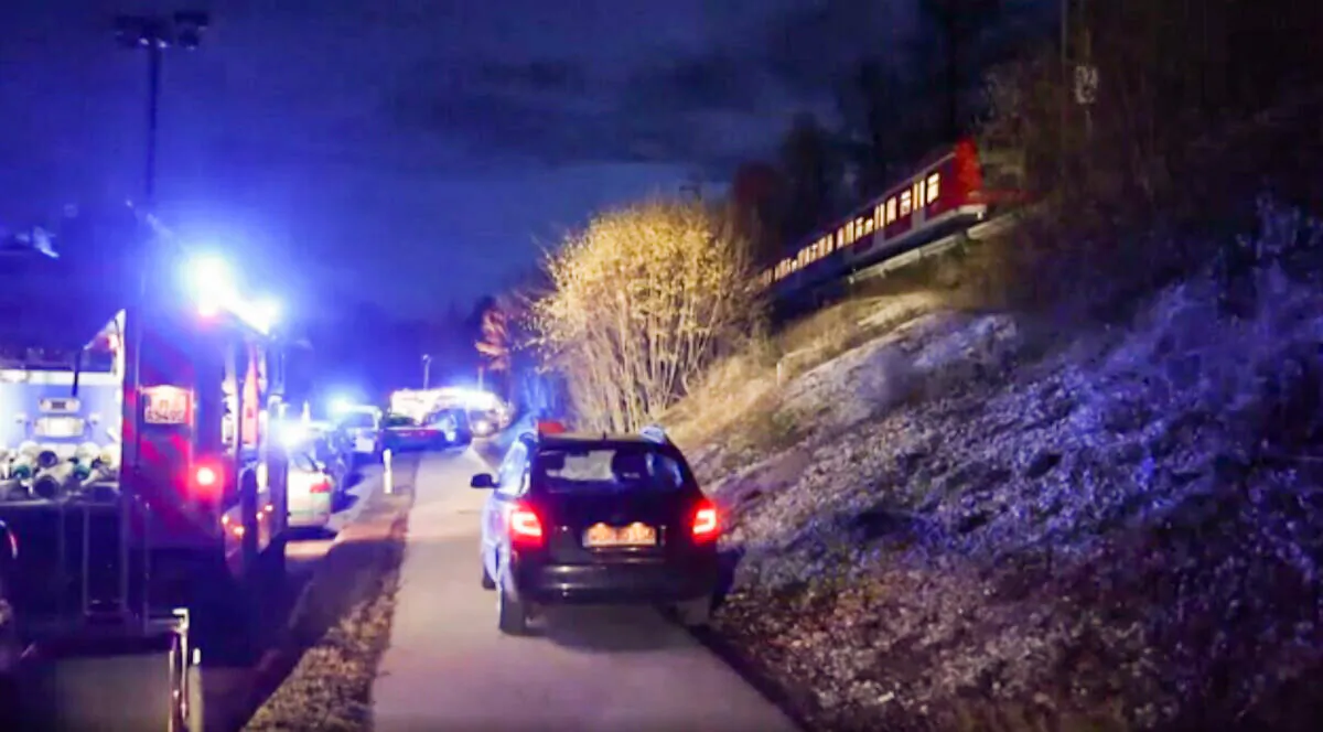 Police cars at the scene of a collision between two commuter trains near Munich, on Feb. 14, 2022. (AP/Screenshot via The Epoch Times)
