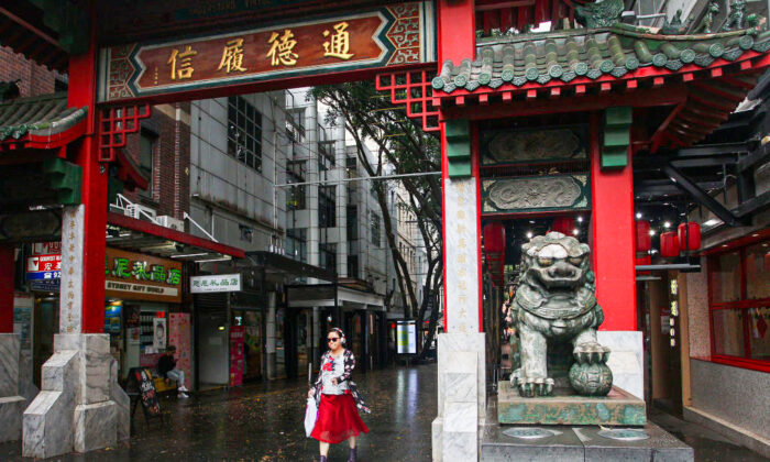 A woman walks through the Chinatown district arch on March 04, 2020 in Sydney, Australia. (Lisa Maree Williams/Getty Images)