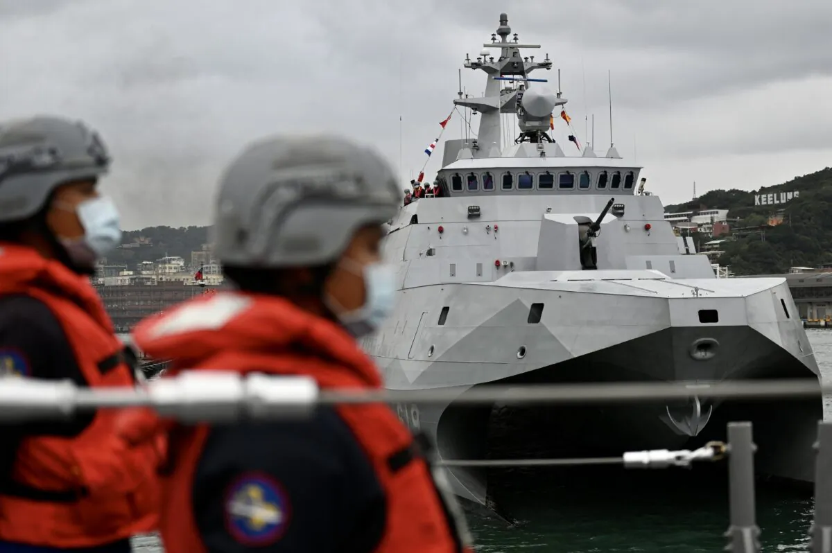 Taiwan soldiers stand next to the domestically produced corvette class vessel Tuo Chiang (R) during a drill at the northern city of Keelung on Jan. 7, 2022. (Sam Yeh/AFP via Getty Images)