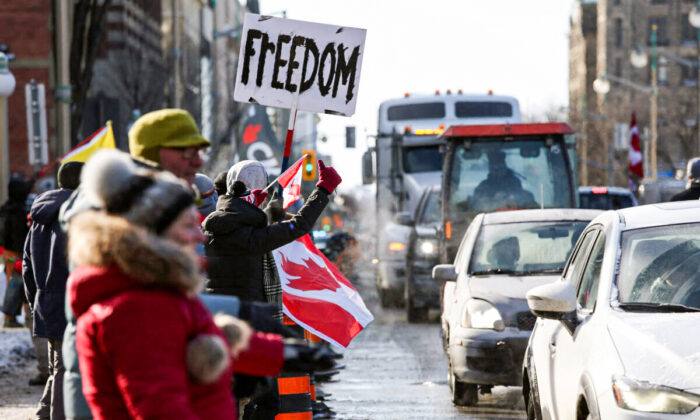 Supporters of the Freedom Convoy protest against COVID-19 vaccine mandates and restrictions gather in front of the Parliament Buildings in Ottawa on Jan. 28, 2022. (Dave Chan/AFP via Getty Images)