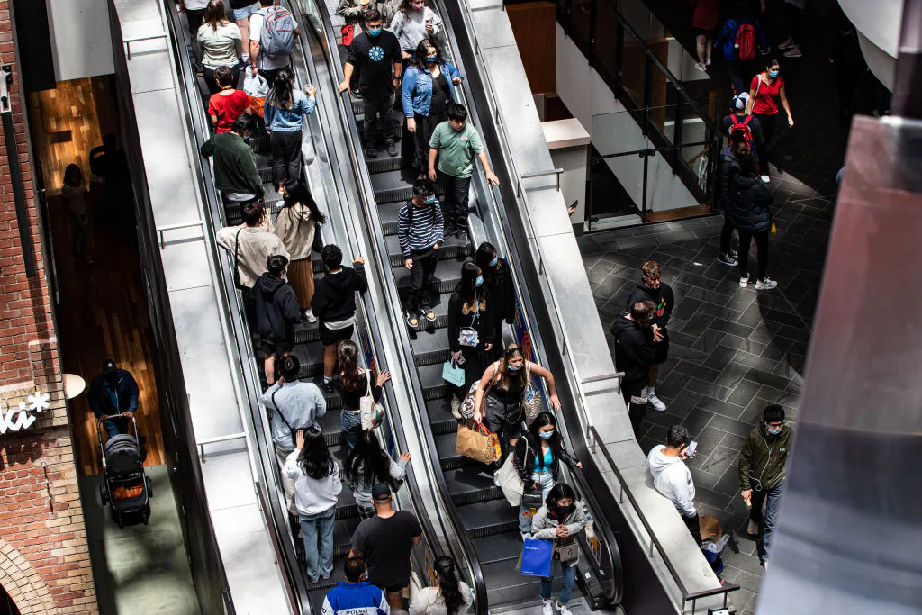 Shoppers ride an escalator at Melbourne Central during the Boxing Day sales in Melbourne, Australia, on Dec. 26, 2021. (Diego Fedele/Getty Images)