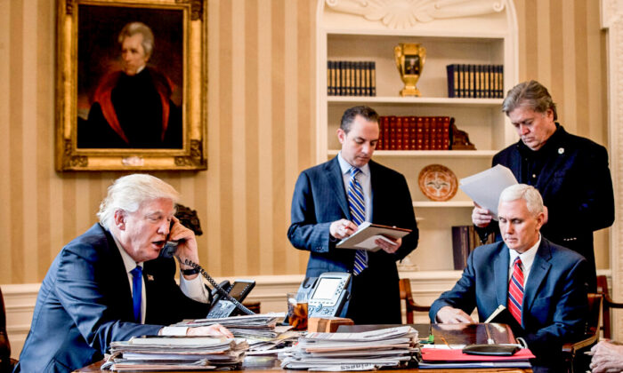 U.S. President Donald Trump speaks on the phone with Russian President Vladimir Putin in the Oval Office of the White House, on Jan. 28, 2017. (Drew Angerer/Getty Images)