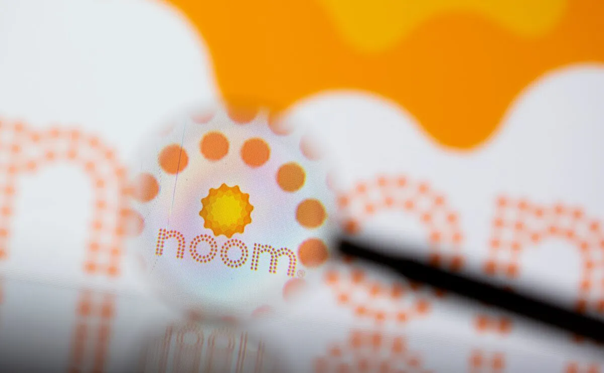 Noom logo is seen through magnifier in a photo illustration on July 13, 2021. (Dado Ruvic/Reuters)