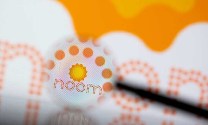 Noom logo is seen through magnifier in a photo illustration on July 13, 2021. (Dado Ruvic/Reuters)