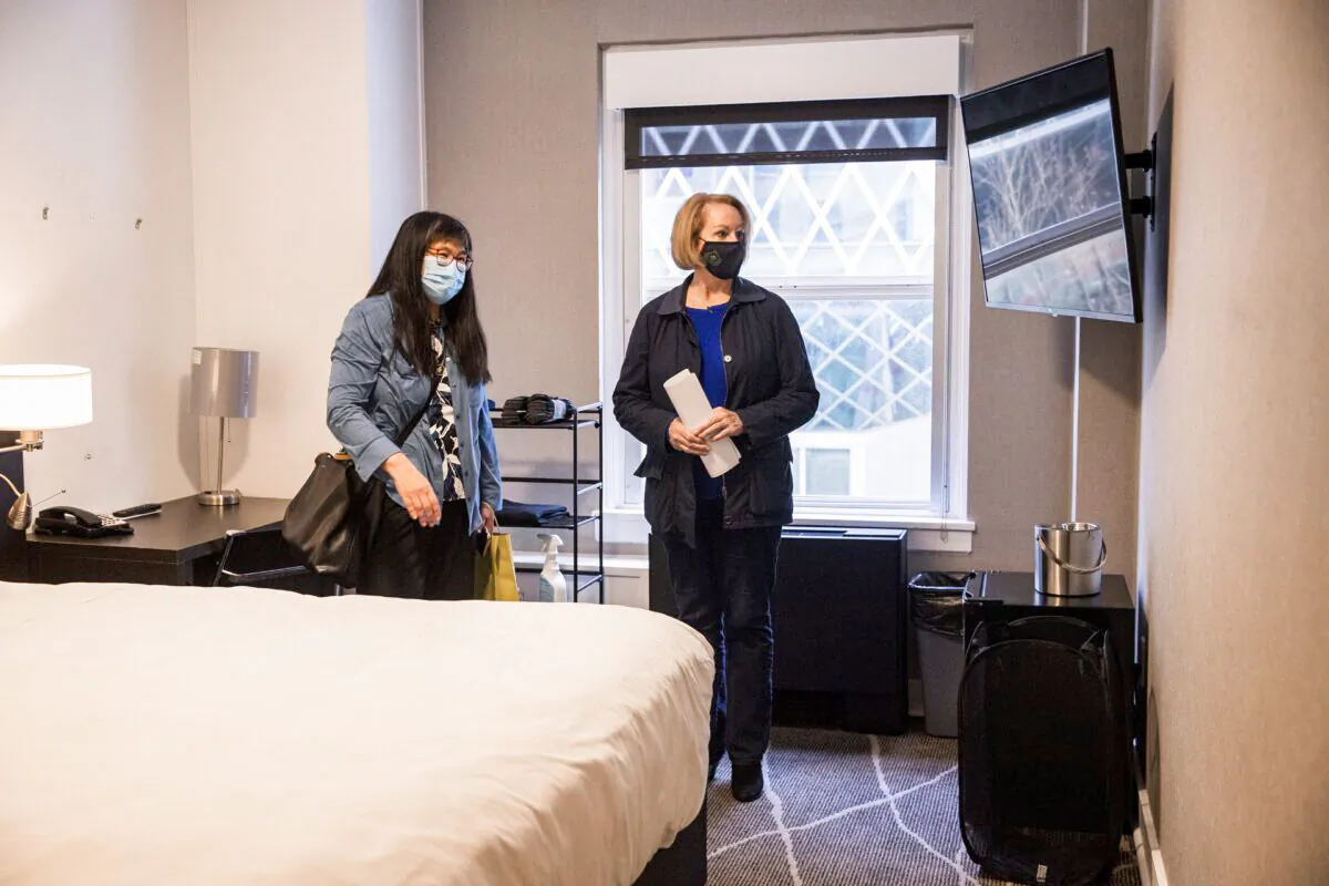 Seattle Mayor Jenny Durkan, right, is given a tour of a room at Executive Hotel Pacific by Sharon Lee, executive director of the Low Income Housing Institute, on March 23, 2021. (Amanda Snyder/The Seattle Times/TNS)