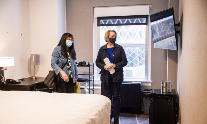 Seattle Mayor Jenny Durkan, right, is given a tour of a room at Executive Hotel Pacific by Sharon Lee, executive director of the Low Income Housing Institute, on March 23, 2021. (Amanda Snyder/The Seattle Times/TNS)
