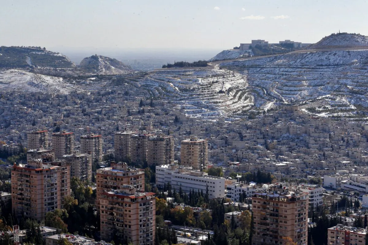 A picture shows snow on Syria's Mount Qasyoun overlooking Damascus' Dummar, on Jan. 20, 2022. (Louai Beshara/AFP via Getty Images)