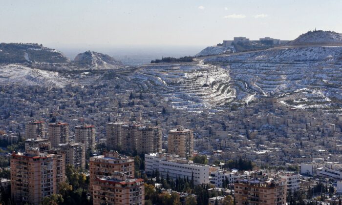 A picture shows snow on Syria's Mount Qasyoun overlooking Damascus' Dummar, on Jan. 20, 2022. (Louai Beshara/AFP via Getty Images)