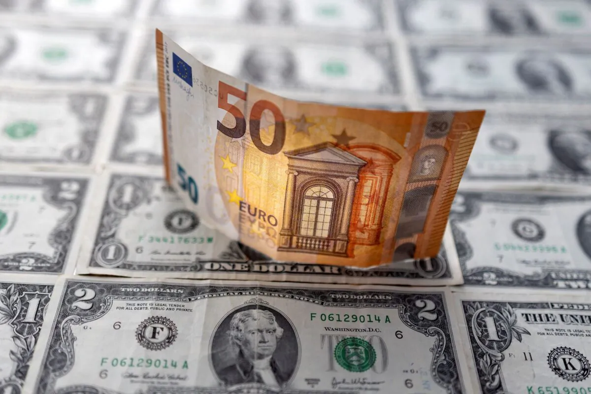 A Euro banknote is displayed on U.S. Dollar banknotes in this illustration taken, on  Feb. 14, 2022. (Dado Ruvic/Illustration/Reuters)