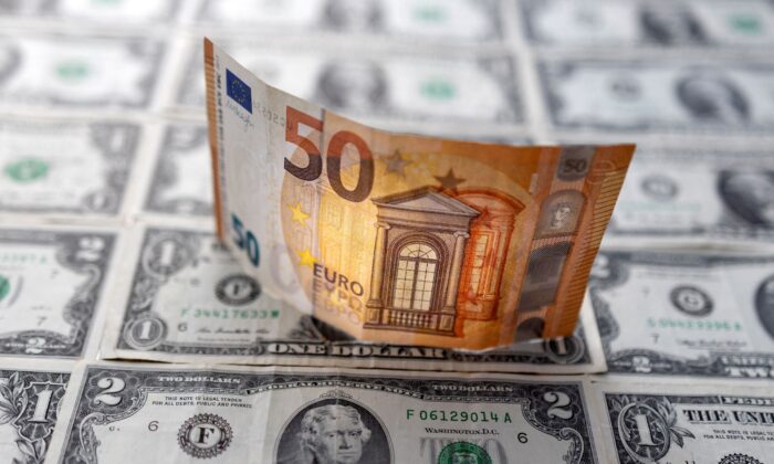 A Euro banknote is displayed on U.S. Dollar banknotes in this illustration taken, on  Feb. 14, 2022. (Dado Ruvic/Illustration/Reuters)
