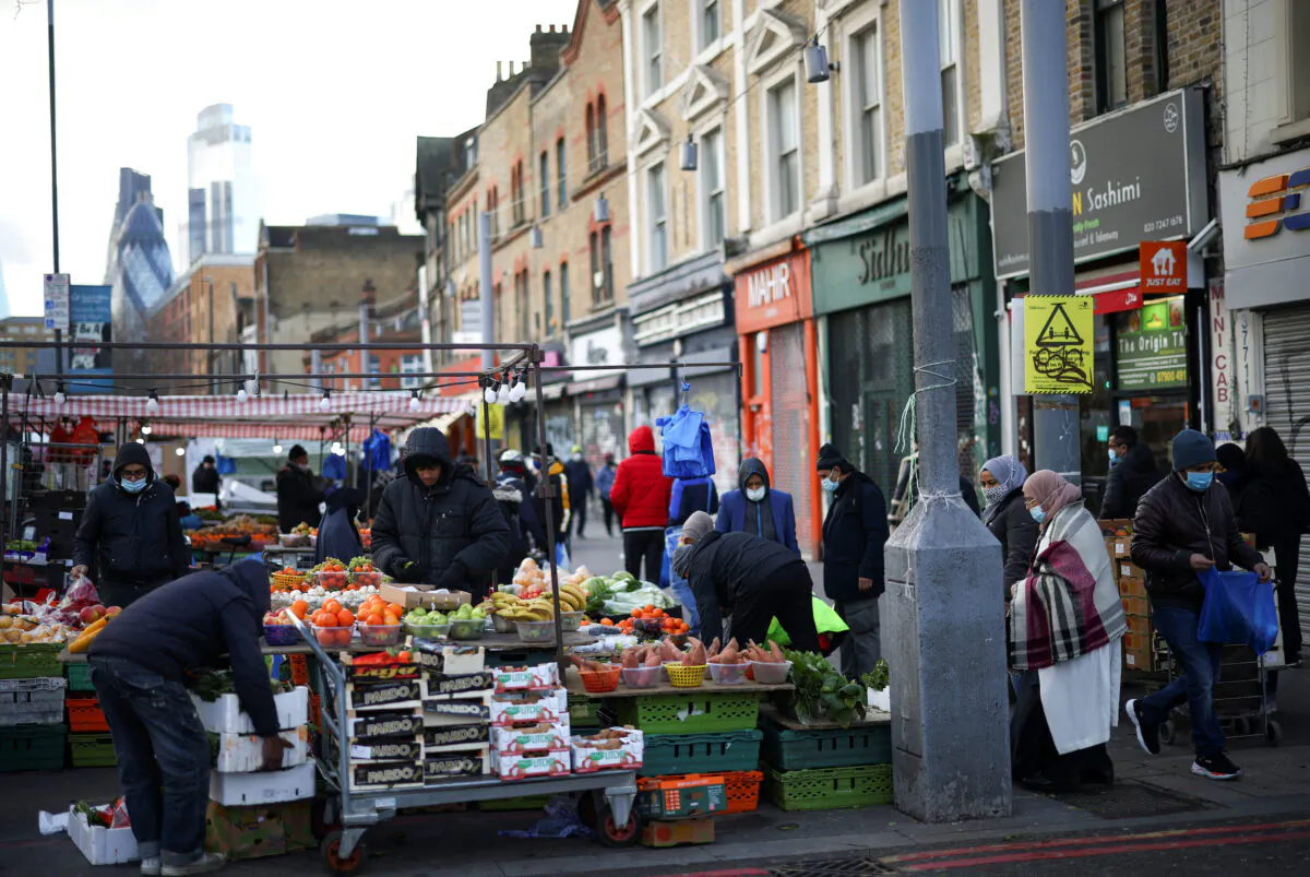 People shop at a market stalls in east London on Jan. 23, 2021. (Henry Nicholls/Reuters)
