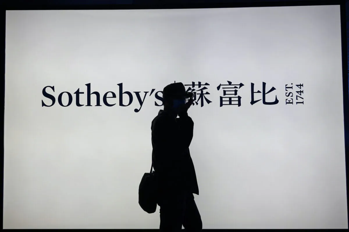 A man walks past a Sotheby's sign at its spring sales exhibition at the Hong Kong Convention and Exhibition Centre on April 16, 2021. (Joyce Zhou/Reuters)