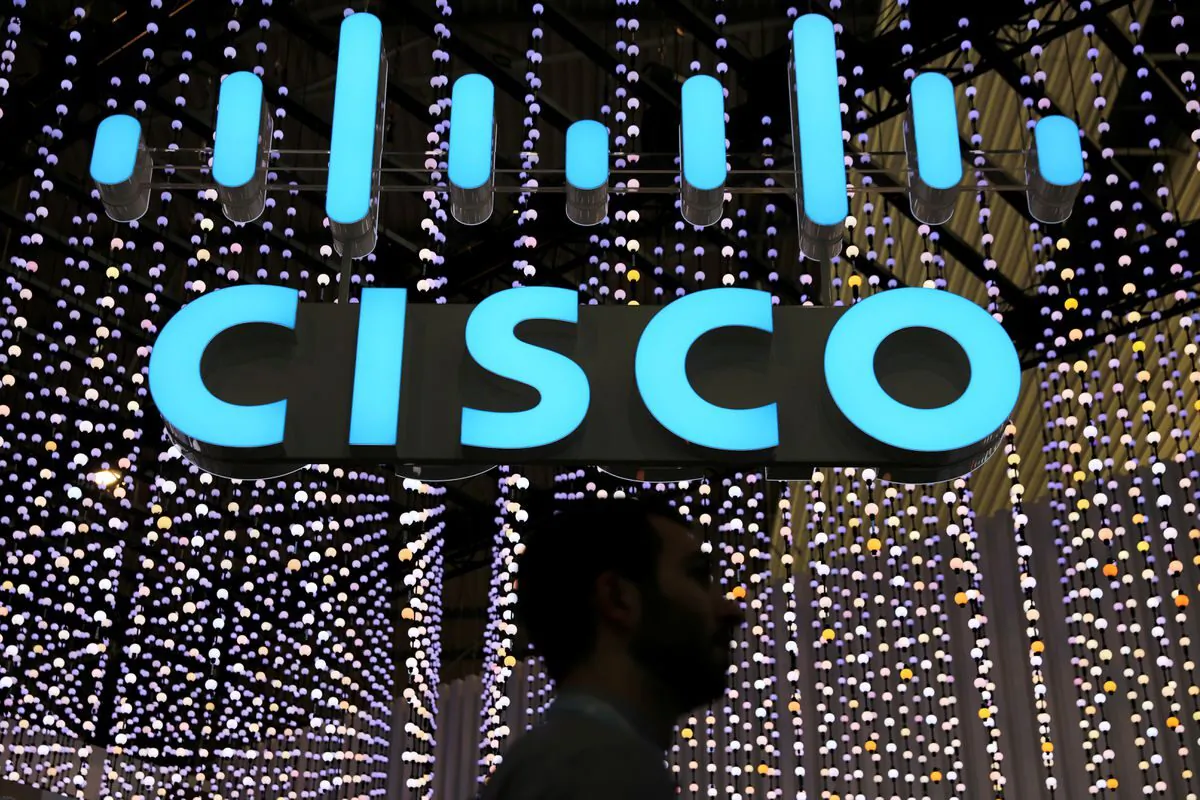 A man passes under a Cisco logo at the Mobile World Congress in Barcelona, Spain, on Feb. 25, 2019. (Sergio Perez/Reuters)