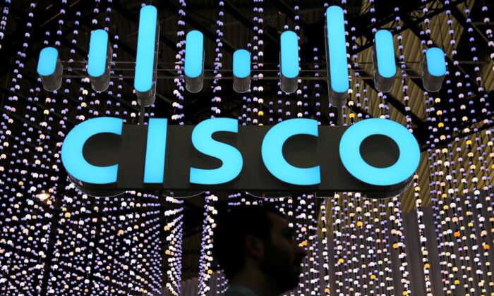 A man passes under a Cisco logo at the Mobile World Congress in Barcelona, Spain on Feb. 25, 2019. (Sergio Perez/Reuters File Photo)