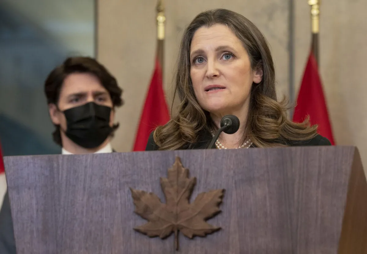 Prime Minister Justin Trudeau looks on as Deputy Prime Minister Chrystia Freeland speaks during a news conference announcing that the Emergencies Act will be invoked to deal with the trucker protests, in Ottawa on Feb. 14, 2022. (The Canadian Press/Adrian Wyld)