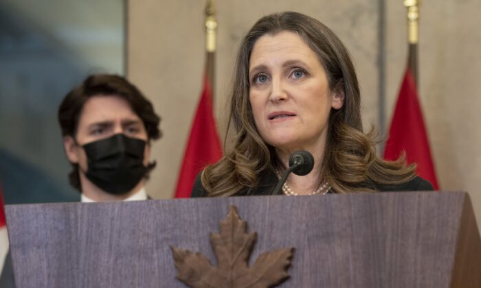 Prime Minister Justin Trudeau looks on as Deputy Prime Minister Chrystia Freeland speaks during a news conference announcing that the Emergencies Act will be invoked to deal with the trucker protests, in Ottawa on Feb. 14, 2022. (The Canadian Press/Adrian Wyld)