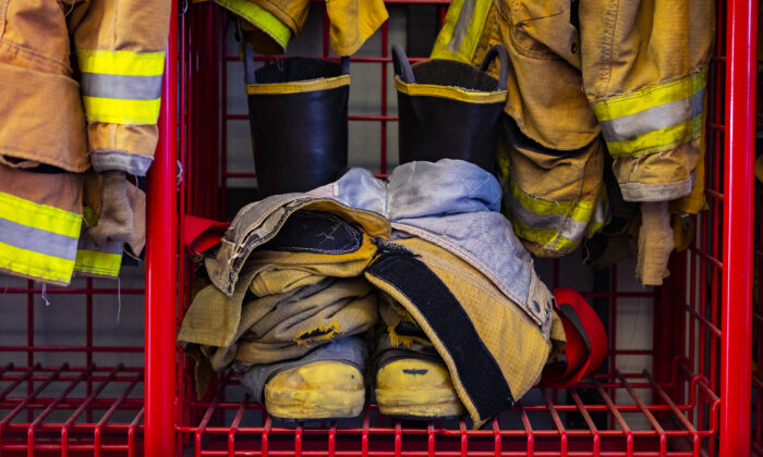 Boots and fire jackets hang near a firetruck belonging to the Orange County Fire Department in Buena Park, Calif., on Jan. 15, 2021. (John Fredricks/The Epoch Times)